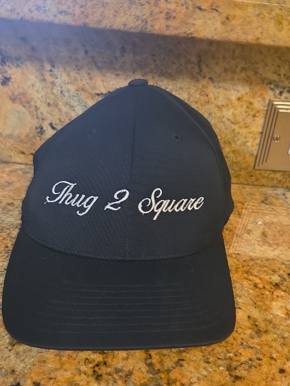 Sport-Tek Black Hat with White Embroidered "Thug 2 Square"